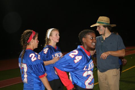 Senior Spencer Hoagland gives classmate Naomi Jones and others instructions for the second half of last year's Powderpuff game.