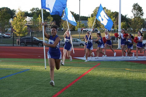 Wade, senior captain of the cheerleading team, in action during a football game last season.