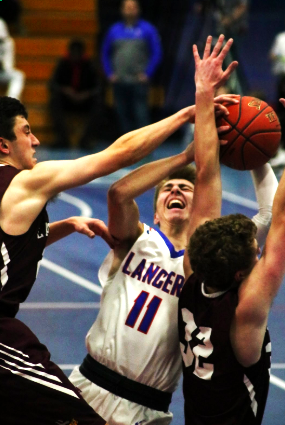 Payton Sutman, junior, battles for the ball against East Lyme's players.
