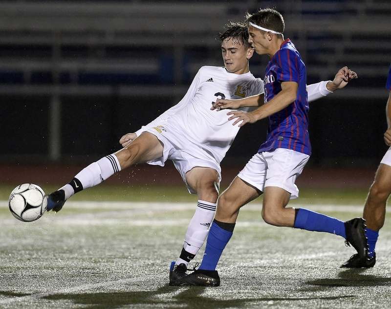 Abe Gollsneider (right) goes for the ball.