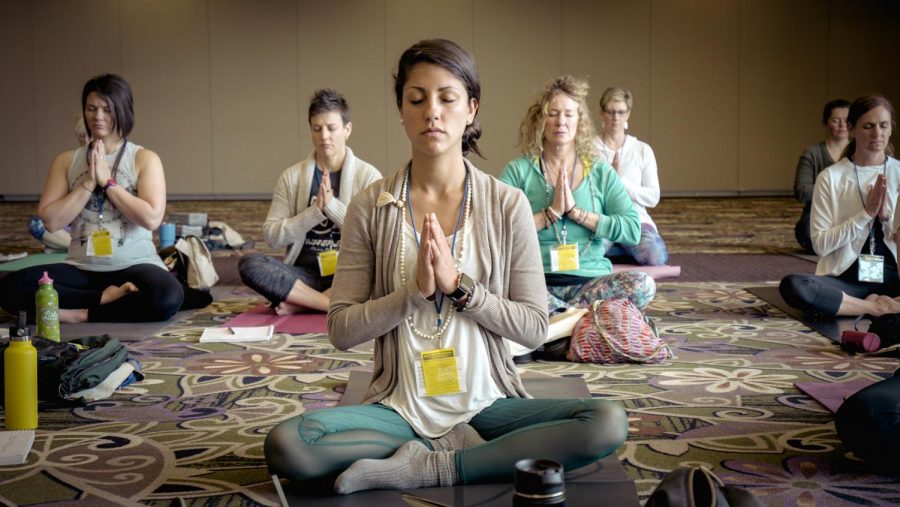 A group taking a meditation class.