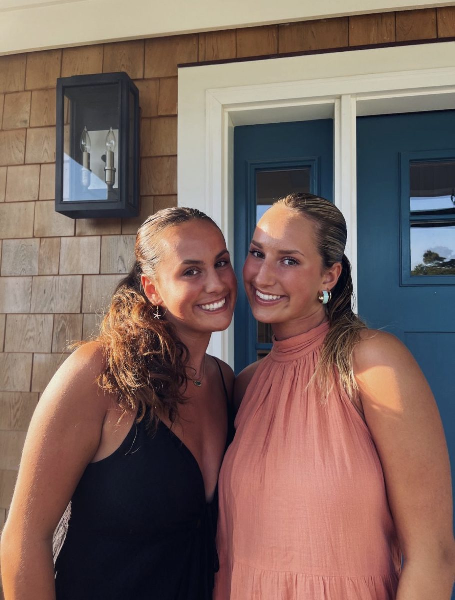 Sisters Lily and Olivia Marelli posing with matching slick back hairstyles.