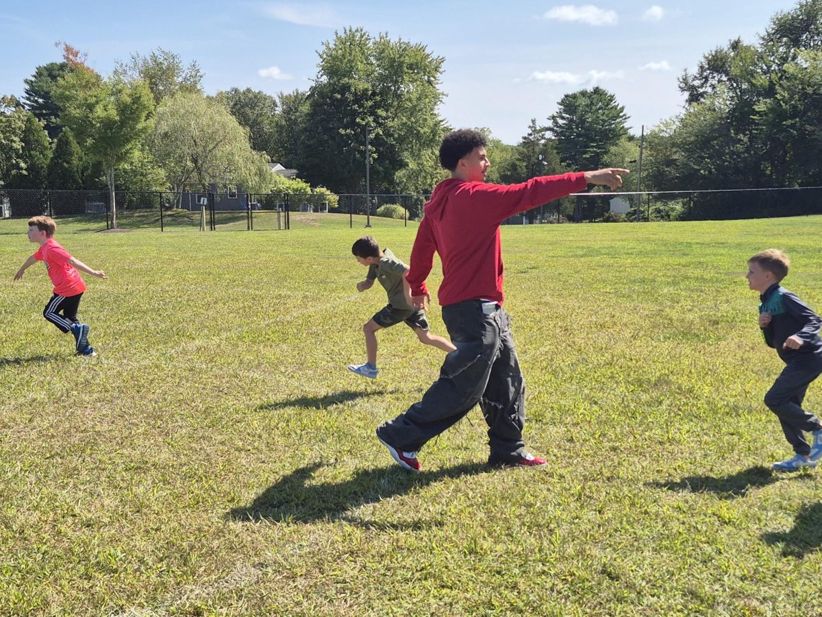 Missael Urena Molina playing soccer with fifth graders from Oswegatchie Elementary School.